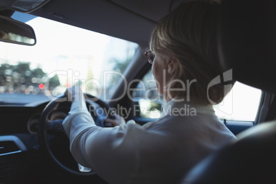 Rear view of businesswoman driving