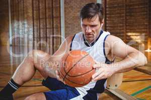 Basketball player looking at ball