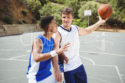 Confident players playing basketball