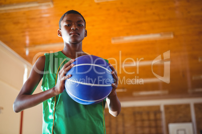 Low angle portrait teenager holding ball
