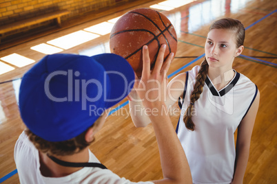 High angle view of male coach training female basketball player
