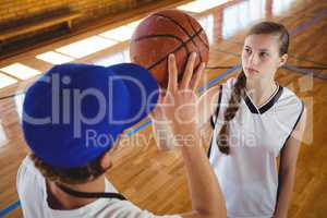 High angle view of male coach training female basketball player