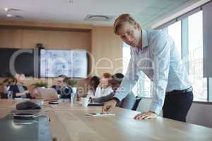 Portrait of businessman using digital tablet on desk