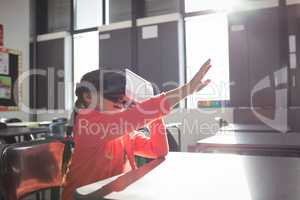 Girl gesturing while using virtual reality glasses