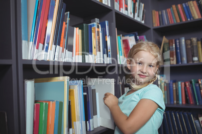 Girl choosing book from shelf