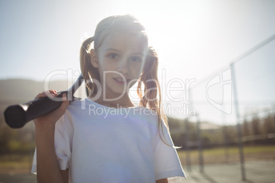 Girl with tennis racket on sunny day