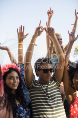 Young friends dancing during music festival