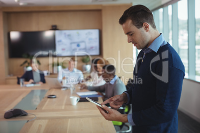 Young businessman using digital tablet