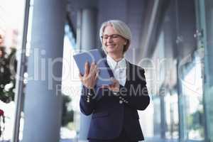 Smiling businesswoman using digital tablet