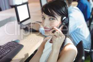 Portrait of young businesswoman using headset
