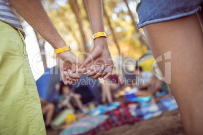 Cropped image of couple hooking pinky fingers