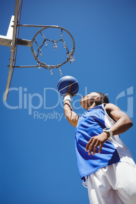 Low angle view of teenager playing basketball