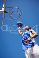 Low angle view of teenager playing basketball