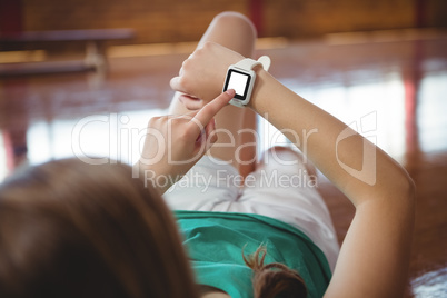 Woman using smart watch in basketball court
