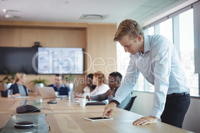 Businessman using digital tablet on desk