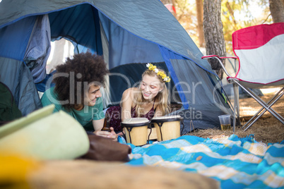 Smiling couple relaxing in tent