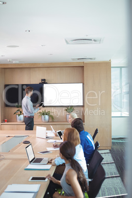 High angle view of business people at conference table during meeting
