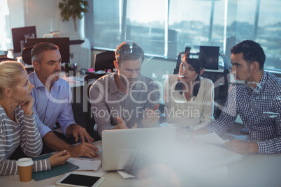 Business partners seen through glass discussing in meeting