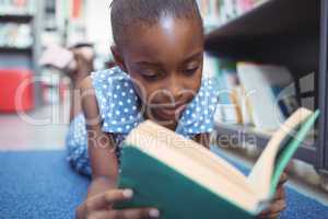 Close up of girl reading book in library