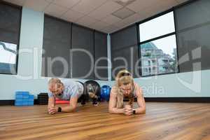 Young friends exercising on hardwood floor