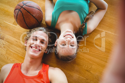 Overhead portrait of smiling friends lying on floor