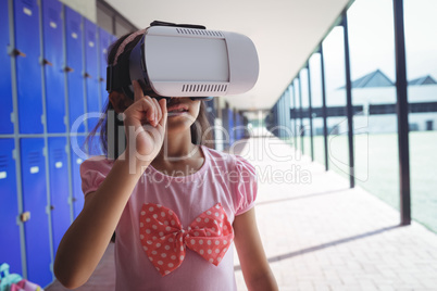 Elementary student using virtual reality glasses in corridor