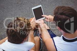 Overhead view of basketball players using digital tablet