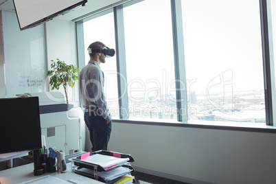 Businessman using virtual reality glasses at office