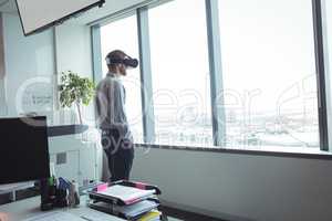 Businessman using virtual reality glasses at office