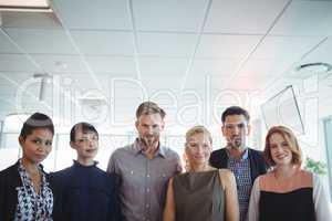 Portrait of young business people standing together