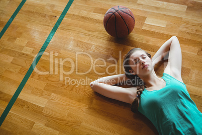 Female basketball player sleeping in court