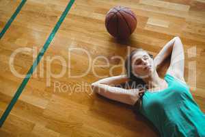 Female basketball player sleeping in court