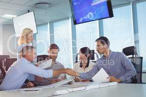 Business partners shaking hands in metting
