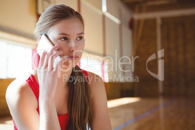 Close up of female basketball player talking on phone