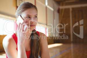 Close up of female basketball player talking on phone