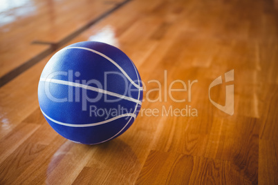 Close up of blue basketball on hardwood floor