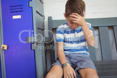 Sad boy sitting on bench