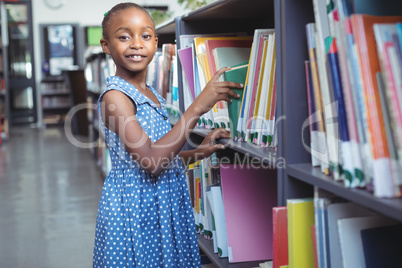 Girl selecting book in library