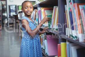 Girl selecting book in library