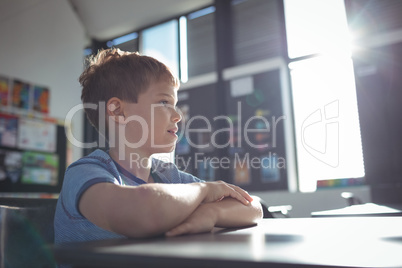 Boy looking away while sitting in classroom