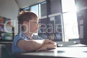 Boy looking away while sitting in classroom