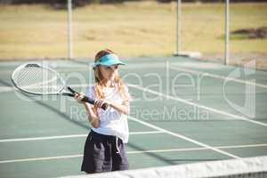 Girl playing tennis on sunny day