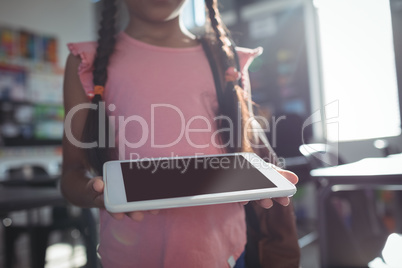 Midsection of girl using digital tablet