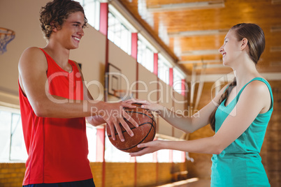 Happy basketball players holding ball
