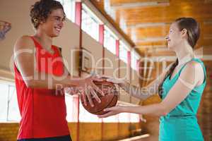 Happy basketball players holding ball