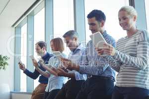 Business colleagues using digital tablets at office