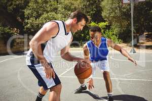 Happy friends playing basketball