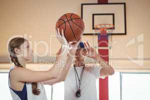 Coach advising female basketball player