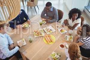 Business coworkers having breakfast at office cafeteria
