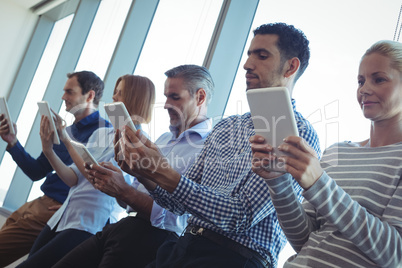 Business people using digital tablets at office